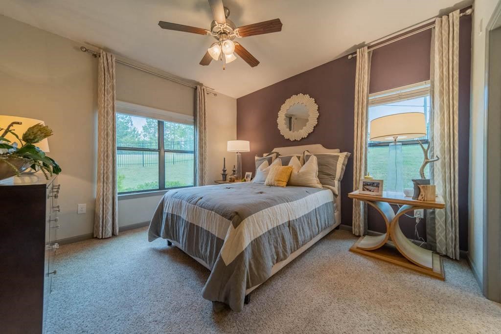 a bedroom with a bed and a ceiling fan